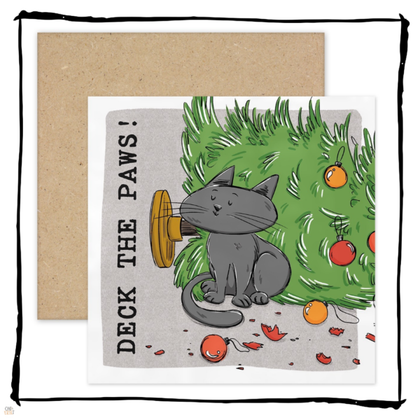 Grey cat sitting beside a fallen Christmas tree and broken baubles on a Deck the Paws Christmas card.
