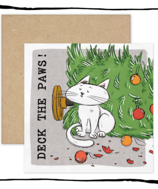 White cat sitting beside a fallen Christmas tree and broken baubles on a Deck the Paws Christmas card.