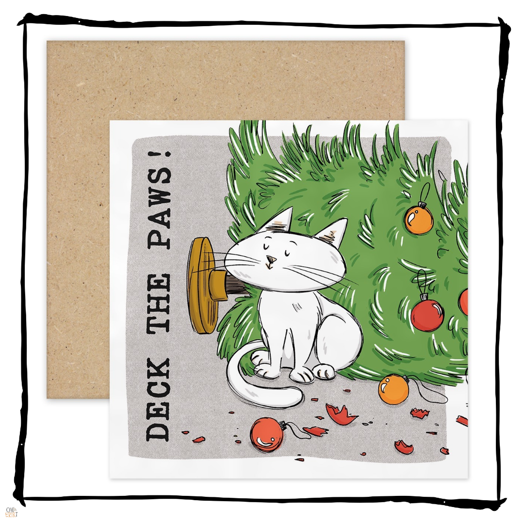 White cat sitting beside a fallen Christmas tree and broken baubles on a Deck the Paws Christmas card.
